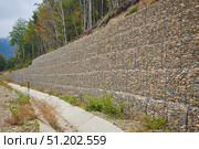 Construction and strengthening of roads from landslides. Stones in a metal mesh, gabions. Technologies in road construction. Стоковое фото, фотограф Наталия Кирсанова / Фотобанк Лори