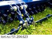 Agricultural machinery close-up with metal components and red frame. Стоковое фото, фотограф Вербицкая Светлана / Фотобанк Лори