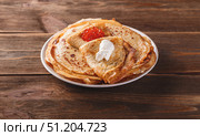 Stack of russian pancakes blini with red caviar, fresh sour cream. Стоковое фото, фотограф Ирина Буракова / Фотобанк Лори