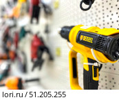 A yellow Deetzel tool is hanging on a wall.  Russia. Moscow. 24.08.25. Редакционное фото, фотограф Ярославский Максим / Фотобанк Лори