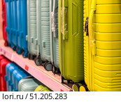 A row of colorful suitcases are on display in a store.  Russia. Moscow. 24.08.25. Редакционное фото, фотограф Ярославский Максим / Фотобанк Лори