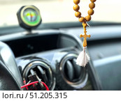 A car with a cross hanging from the rearview mirror. Стоковое фото, фотограф Ярославский Максим / Фотобанк Лори