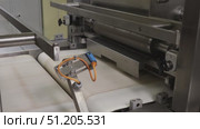 conveyor at a confectionery factory coating wafer plates with chocolate mass and assembling wafers. Стоковое видео, видеограф Алексей Сергеев / Фотобанк Лори