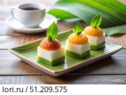 Three Layered Indonesian Desserts With Mango Topping and Green Leaves. Generative AI. Стоковое AI-изображение, AI-художник Roman Zavorotny / Фотобанк Лори