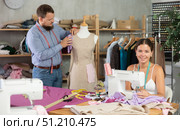 Male dressmaker working with mannequin while girl sews. Стоковое фото, фотограф Яков Филимонов / Фотобанк Лори