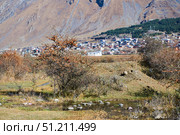 The Caucasus Mountains in Georgia and the village of Stepantsminda in the distance. The natural landscape. High peaks. The season is autumn. Стоковое фото, фотограф Наталия Кирсанова / Фотобанк Лори