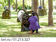 Saint Petersburg, Russia, 7 July 2019, Children play paintball outside in park. Редакционное фото, фотограф Spirit River / Фотобанк Лори