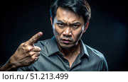 An Angry Thai Man Points Accusatorially in a Dramatic Portrait. Generative AI. Стоковое AI-изображение, AI-художник Roman Zavorotny / Фотобанк Лори
