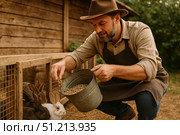 A Farmer Feeding a Group of Rabbits in a Rustic Setting: A Scene of Animal Care and Farming Dedication. Стоковое AI-изображение, AI-художник Башкирова Анна / Фотобанк Лори