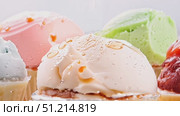 Indulge in the refreshing taste of homemade sorbet crafted from vibrant fruits garnished with nuts, perfect for summer enjoyment. Стоковое AI-видео, аниматор Данила Большаков / Фотобанк Лори