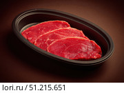 Beef. Fresh Black Angus Prime raw beef steaks. A slices of red meat fillet mignon. Ribeye, rib eye. Uncooked tender marbled striploin steak on dark background. Preparation for cooking. Butcher Shop. Стоковое AI-изображение, AI-художник Марина Демидюк / Фотобанк Лори