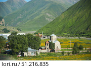 Gudauri, Georgia. - July 03, 2023: Church in the village. The high Caucasus Mountains. Редакционное фото, фотограф Наталия Кирсанова / Фотобанк Лори