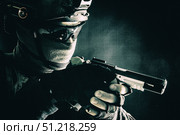 Police SWAT team fighter aiming pistol while sneaking in the darkness. Oleg Zabielin / Stocktrek Images/TASS. Стоковое фото, агентство ТАСС / Фотобанк Лори