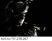 Police SWAT team fighter aiming pistol while sneaking in the darkness. Oleg Zabielin / Stocktrek Images/TASS. Стоковое фото, агентство ТАСС / Фотобанк Лори