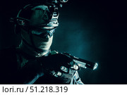 Police SWAT team fighter aiming pistol while sneaking in the darkness. Oleg Zabielin / Stocktrek Images/TASS. Стоковое фото, агентство ТАСС / Фотобанк Лори