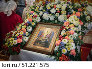 Traditional festive decoration with flowers, apples and mountain ash for Transfiguration icon in Orthodox church, Russia. Редакционное фото, фотограф irisff / Фотобанк Лори