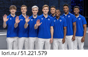 Professional esports team posing together, wearing matching blue jerseys and white pants, displaying number five hand gesture after tournament ranking achievement. Стоковое AI-изображение, AI-художник Юрий Поздников / Фотобанк Лори