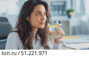 Professional businesswoman sipping lemon water at modern workspace, practicing wellness with mindful hydration during productive workday. Стоковое AI-видео, аниматор Юрий Поздников / Фотобанк Лори