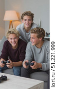 Young male siblings closely seated on home couch, intensely competing during multiplayer video game session, sharing gaming excitement and brotherly bond. Стоковое AI-видео, аниматор Юрий Поздников / Фотобанк Лори