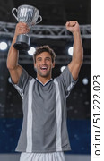 Professional soccer player lifting championship trophy overhead, expressing pure joy and triumph after winning crucial match in packed stadium. Стоковое AI-видео, аниматор Юрий Поздников / Фотобанк Лори