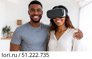 Digital world, newest technologies for entertainment concept, collage. Young couple in white t-shirts using modern virtual glasses, making hands movements isolated in neon, panorama. Стоковое AI-изображение, AI-художник ALLA YURTAYEVA / Фотобанк Лори