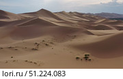 Aerial view of sand dunes in desert at sunset. Стоковое фото, фотограф Михаил Коханчиков / Фотобанк Лори