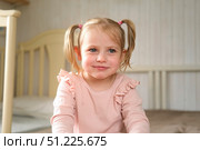 Little Girl joking sticking tongue out with silly expression. Child making face. Funny foolishness portrait of baby girl laughing in bedroom. Adorable Caucasian kid doing crazy comical gesture at home. Стоковое фото, фотограф Марина Демидюк / Фотобанк Лори