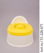 White baby potty with yellow lid on grey background. Стоковое фото, фотограф Катерина Белякина / Фотобанк Лори