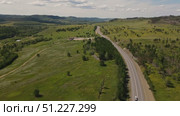 Explore the winding road through lush greenery in beautiful countryside. Стоковое видео, видеограф Гурьянов Андрей / Фотобанк Лори