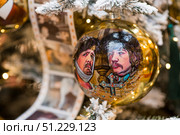 A decorated Christmas tree of the Mosfilm film company with portraits of actors from popular Soviet films, in the GUM store in the center of Moscow. Russia, Moscow, January 9, 2025. Редакционное фото, фотограф Photojuli / Фотобанк Лори
