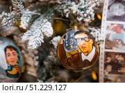 A decorated Christmas tree of the Mosfilm film company with portraits of actors from popular Soviet films, in the GUM store in the center of Moscow. Russia, Moscow, January 9, 2025. Редакционное фото, фотограф Photojuli / Фотобанк Лори