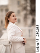 Woman Blazer Outdoors: Pensive woman in blazer outside, day, reflecting, holding glasses for style. Стоковое фото, фотограф svetograph / Фотобанк Лори