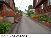 Yuryevets, Ivanovo region, Russia, July 24, 2025: View of Engels Lane on way to 18th century Epiphany Church. Редакционное фото, фотограф Алексей Антипов / Фотобанк Лори