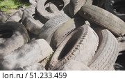 A large collection of old, worn-out tires is observed in an urban environment, emphasizing waste management challenges and the need for recycling solutions. Стоковое видео, видеограф Громов Александр / Фотобанк Лори