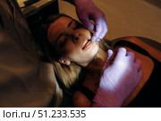 Engagement in a Dental Procedure Carried Out Under Dim Lighting for Best Results and Comfort. Стоковое фото, фотограф Cantemir Dumitru / Фотобанк Лори