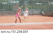 Female athlete plays tennis on open court. Стоковое видео, видеограф Яков Филимонов / Фотобанк Лори