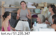 Young woman teacher conducts master class on sewing. Стоковое видео, видеограф Яков Филимонов / Фотобанк Лори