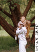 Mother hugging pacifying sad upset stressed crying toddler girl. Стоковое фото, фотограф Любовь Каплицкая / Фотобанк Лори