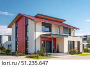 House Exterior. Roof Window. Second floor among blue sky. Mansard attic. Newly build houses. Gable roof with skylight, asphalt roofing, shingles. Residential Home. Vinyl Siding. Polymeric roof-tiles. Стоковое AI-изображение, AI-художник Марина Демидюк / Фотобанк Лори