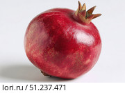 Pomegranates. Pomegranate isolated on a white transparent background. Juicy garnet fruit whole and its half with leaves and details. Piece of pomegranate with seeds. Side view. Freshness and abundance. Стоковое AI-изображение, AI-художник Марина Демидюк / Фотобанк Лори
