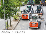 Row of Bobcat skid steer loaders with buckets. London, UK, 14 July 2024. Редакционное фото, фотограф Zydrius Tartenis / Фотобанк Лори