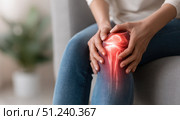 Knee pain icon. Joint pain, Arthritis and tendon problems. Woman in jeans sitting sofa, touching nee at pain point. Mature person feeling unwell, suffering from pain in leg. Red effect painful injury. Стоковое AI-изображение, AI-художник Марина Демидюк / Фотобанк Лори