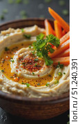 Hummus served in bowl with carrots and herbs on dark background. Стоковое AI-видео, аниматор KATERINA AI / Фотобанк Лори
