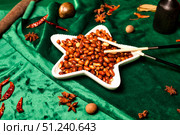 Spiced Peanuts in a Star Shaped Bowl With Chopsticks on Green Silk. Стоковое фото, фотограф Aleksandr Golubev / Фотобанк Лори