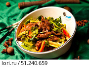 Savoring the Spices of Sichuan Cuisine in a Chinese Restaurant at Dusk. Стоковое фото, фотограф Aleksandr Golubev / Фотобанк Лори