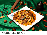 Golden Noodles and Savory Beef Dish at a Vibrant Chinese Establishment. Стоковое фото, фотограф Aleksandr Golubev / Фотобанк Лори