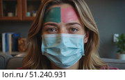 Woman with painted face wearing a mask at home during pandemic. Стоковое AI-видео, аниматор KATERINA AI / Фотобанк Лори