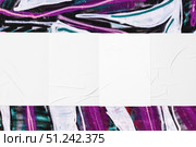 colorful urban wall with four wrinkled glued poster templates. Стоковое фото, фотограф Александра Конопля / Фотобанк Лори