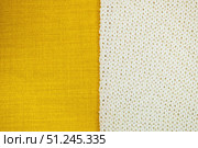 Background from two part yellow textile and white knitting cloth, copy space. Стоковое фото, фотограф Зарифа Арсланова / Фотобанк Лори