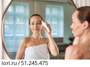 Middle-aged Woman Engages in Skincare Routine With Electrical Device to Reduce Signs of Aging. Стоковое фото, фотограф Aleksandr Golubev / Фотобанк Лори